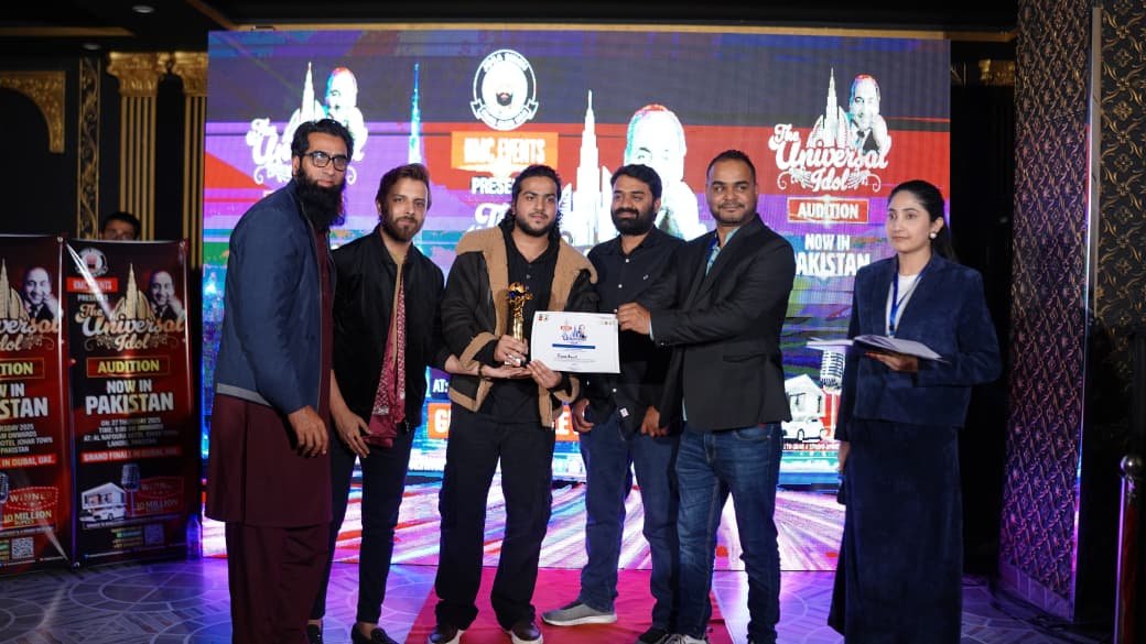 Energetic crowd cheering at live music concert with stage lights